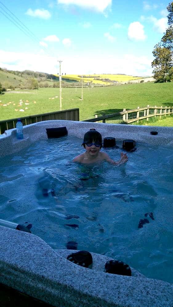 Child in an Arctic Spas Hot tub in the garden